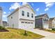 Two-story home featuring a two-car garage, lush green lawn, and beautiful blue skies at 669 Impala Trce, Wendell, NC 27591