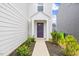Beautiful entryway with manicured bushes surrounding a vibrant purple front door at 669 Impala Trce, Wendell, NC 27591