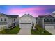 Beautiful two-story home with a two car garage and a well-manicured lawn at dusk at 669 Impala Trce, Wendell, NC 27591