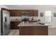 Kitchen featuring an island, stainless steel appliances, granite countertops and wood-look flooring at 669 Impala Trce, Wendell, NC 27591