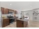 Kitchen featuring stainless steel appliances, granite countertops and wood-look flooring at 669 Impala Trce, Wendell, NC 27591