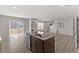 Kitchen featuring an island with granite countertops, a sink and a stainless steel dishwasher at 669 Impala Trce, Wendell, NC 27591