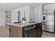 Close-up of kitchen island featuring granite countertops, a sink, and a stainless steel dishwasher at 669 Impala Trce, Wendell, NC 27591
