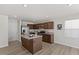 Kitchen featuring an island, stainless steel appliances, granite countertops and wood-look flooring at 669 Impala Trce, Wendell, NC 27591