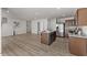 Open concept kitchen view with island, stainless steel appliances, and wood-look flooring at 669 Impala Trce, Wendell, NC 27591