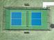 A perfectly maintained community tennis court with blue and green surface and black chain link fence at 669 Impala Trce, Wendell, NC 27591