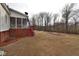 Large backyard with a red deck at 730 Duck Pond Rd, Nashville, NC 27856