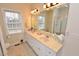 Bright bathroom showcasing a double vanity with a large mirror, tiled floors, and a separate shower enclosure at 730 Duck Pond Rd, Nashville, NC 27856