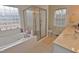 Bathroom featuring a soaking tub, walk-in shower, and dual vanities with marble countertops at 730 Duck Pond Rd, Nashville, NC 27856