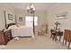 Bright bedroom featuring a four-poster bed, decorative lighting, and classic furnishings at 730 Duck Pond Rd, Nashville, NC 27856