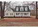 Charming home with welcoming front porch, dormer windows and manicured landscaping at 730 Duck Pond Rd, Nashville, NC 27856