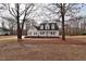Attractive home framed by mature trees, featuring a classic front porch and well-maintained lawn at 730 Duck Pond Rd, Nashville, NC 27856