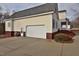 Attached garage and driveway, with landscaped garden bed at 730 Duck Pond Rd, Nashville, NC 27856