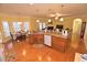 Open kitchen design with granite island, stainless steel appliances, and hardwood floors overlooking the living area at 730 Duck Pond Rd, Nashville, NC 27856