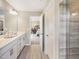 Elegant bathroom featuring a large vanity with double sinks and a glass-enclosed shower at 810 Spoonbill Trl, Durham, NC 27703