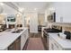 Well-equipped kitchen with white countertops, stainless appliances, and a view to living area at 810 Spoonbill Trl, Durham, NC 27703