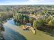 Community aerial view featuring a pond and surrounding trees at 1027 Laurelwood Dr, Durham, NC 27705
