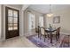 Elegant dining area with a glass-topped table, stylish lighting, and an inviting ambiance at 1027 Laurelwood Dr, Durham, NC 27705