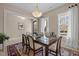 Bright dining room with large windows, contemporary lighting, and a classic table setting at 1027 Laurelwood Dr, Durham, NC 27705