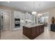 Modern kitchen with granite counters, white cabinets, stainless steel appliances and a large island at 1027 Laurelwood Dr, Durham, NC 27705