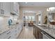 Modern kitchen with granite countertops, stainless steel appliances, and open view to the dining area at 1027 Laurelwood Dr, Durham, NC 27705