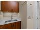 Laundry room with granite countertop, stainless steel sink and white board at 1027 Laurelwood Dr, Durham, NC 27705