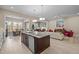 Open concept living area with kitchen island, dining area and a sun-filled living room at 1027 Laurelwood Dr, Durham, NC 27705