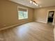 Empty room with vinyl floors, natural light and access to the bathroom at 1027 Laurelwood Dr, Durham, NC 27705