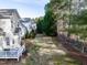 Spacious backyard with a deck, lush lawn, and mature trees providing shade at 1028 Dotson Way, Apex, NC 27523