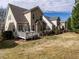 Exterior view of the back of the house with a lawn, decks, siding, and roof at 1028 Dotson Way, Apex, NC 27523