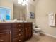 Bathroom with a dark wood vanity, double sinks, and a white toilet at 1028 Dotson Way, Apex, NC 27523