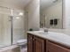 Bathroom featuring glass enclosed shower and a sink with wooden cabinets at 1028 Dotson Way, Apex, NC 27523