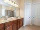 Bathroom with double sinks, a large mirror, vanity, and a tiled shower at 1028 Dotson Way, Apex, NC 27523