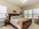 Bedroom with a large bed, two windows, and a rocking chair at 1028 Dotson Way, Apex, NC 27523