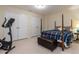 Bedroom with a four-post bed, striped bedding, and exercise bike at 1028 Dotson Way, Apex, NC 27523