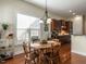 A sunlit breakfast nook with dark hardwood floors and classic-style chandelier at 1028 Dotson Way, Apex, NC 27523