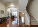 Inviting entryway with hardwood floors, staircase, and arched doorway to the dining room at 1028 Dotson Way, Apex, NC 27523