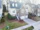 Attractive two-story home with stone accents, a two-car garage, and a well-kept lawn at 1028 Dotson Way, Apex, NC 27523