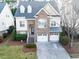 Beautiful two-story home with stone accents, a two-car garage, and manicured lawn at 1028 Dotson Way, Apex, NC 27523