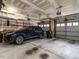 Spacious two car garage with painted walls, a ladder, an SUV and two garage doors at 1028 Dotson Way, Apex, NC 27523