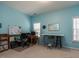 Bright home office with blue walls, two windows, desk and chair at 1028 Dotson Way, Apex, NC 27523