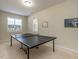 A recreational room with neutral walls and carpet and a ping pong table at 1028 Dotson Way, Apex, NC 27523