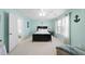Bright bedroom with a ceiling fan, a window with curtains, and an ensuite bathroom at 109 Skywater Ln, Holly Springs, NC 27540