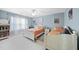 Bright bedroom featuring two twin beds, a window with curtains, and a bedside table at 109 Skywater Ln, Holly Springs, NC 27540