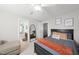 Cozy bedroom featuring a full-size bed, comfortable chair, and doorway access to a connecting bathroom at 109 Skywater Ln, Holly Springs, NC 27540