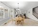 Bright breakfast nook with a round table and natural light with living room in background at 109 Skywater Ln, Holly Springs, NC 27540