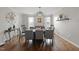 Elegant dining room with hardwood floors, modern lighting, and seating for eight at 109 Skywater Ln, Holly Springs, NC 27540