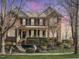 Traditional brick home with inviting front porch, manicured landscaping, and elegant curb appeal at 109 Skywater Ln, Holly Springs, NC 27540