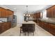 Spacious kitchen featuring stainless steel appliances, wooden cabinets, and a large center island at 109 Skywater Ln, Holly Springs, NC 27540