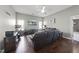 Cozy living room boasts hardwood floors, a ceiling fan and plenty of natural light from the large windows at 109 Skywater Ln, Holly Springs, NC 27540